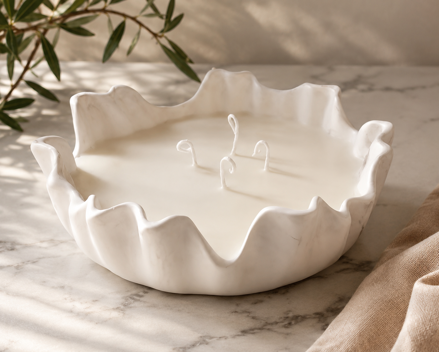 large marble effect concrete resin flowy edge candle bowl with flowing edges and filled with beautifully scented soy wax and 4 candle wicks