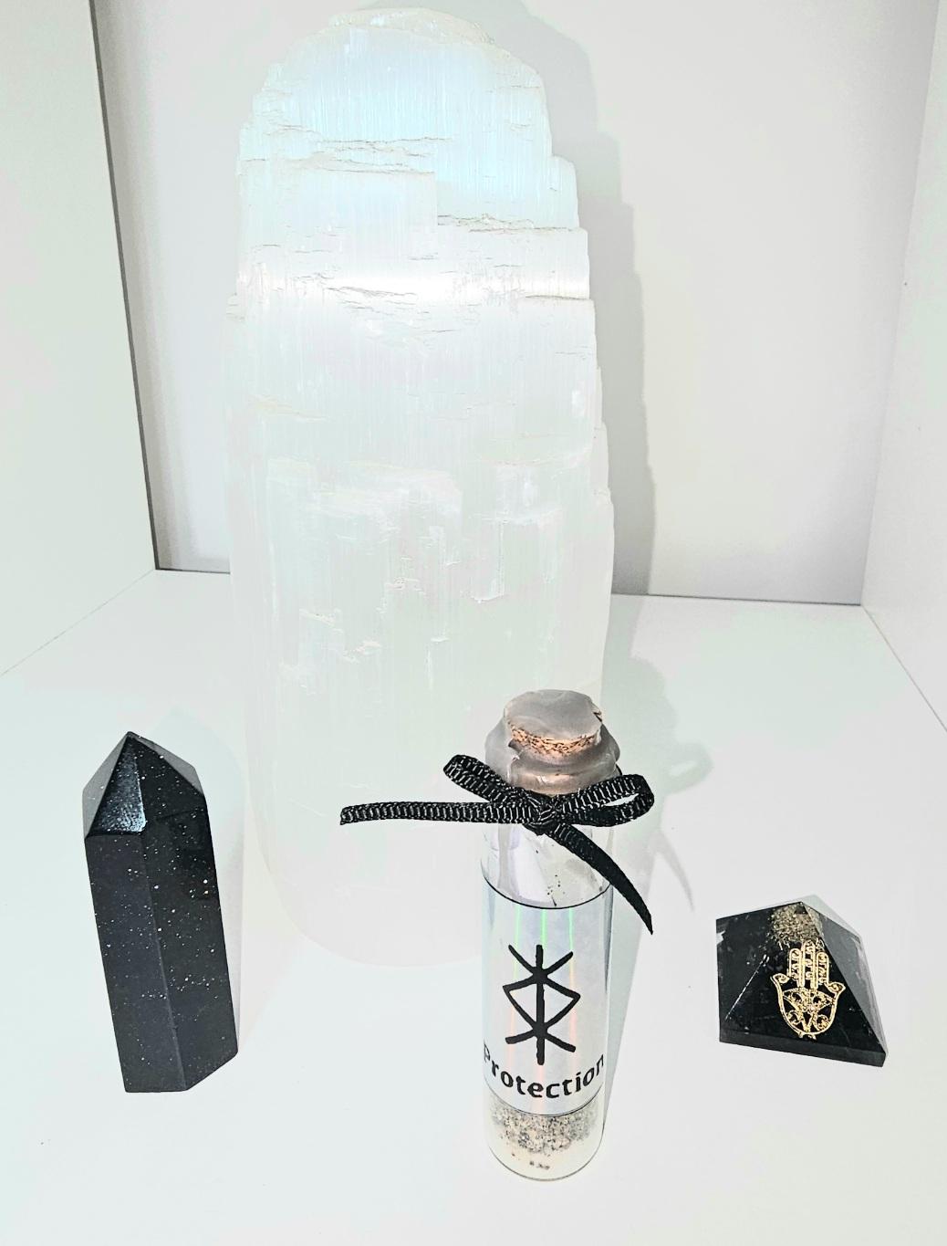 A clear small glass spell jar with a silver holographic label on the front containing a protective sigil. The jar has a cork stopper that is sealed with black wax and is filled with a small scroll and protective herbs. The jar is also topped off with a black decorative bow.